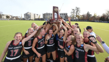 The St. Joe's field hockey team, holds up a trophy as they celebrate their NCAA Final Four berth.